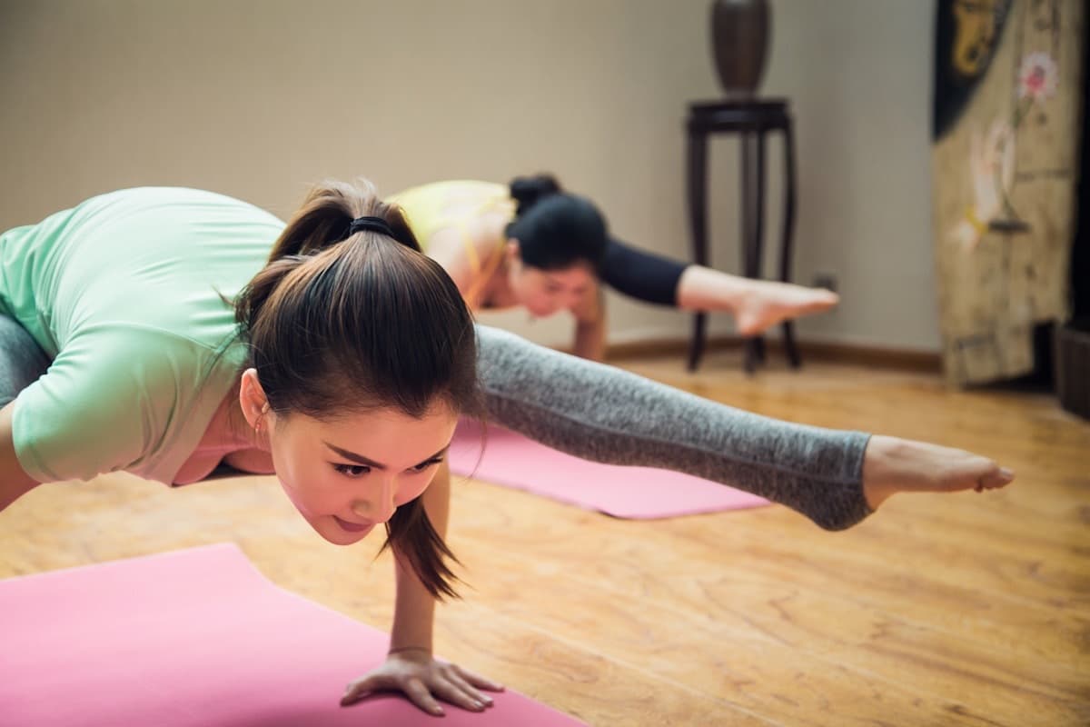 Patients doing physiotherapy rehabilitation exercises on yoga mats
